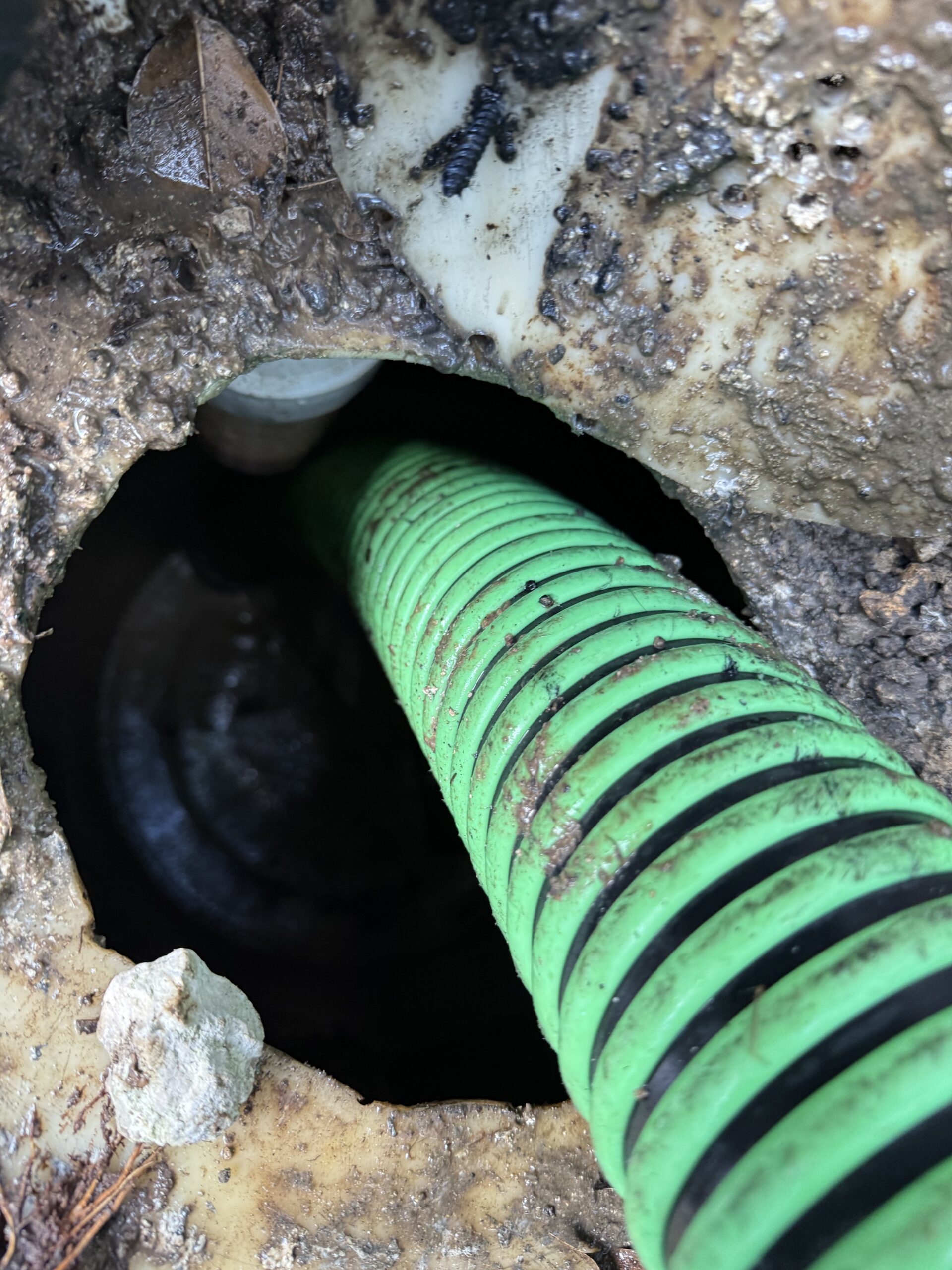 Technician performing septic tank pumping in Miami using a vacuum truck, Miami-Dade County.