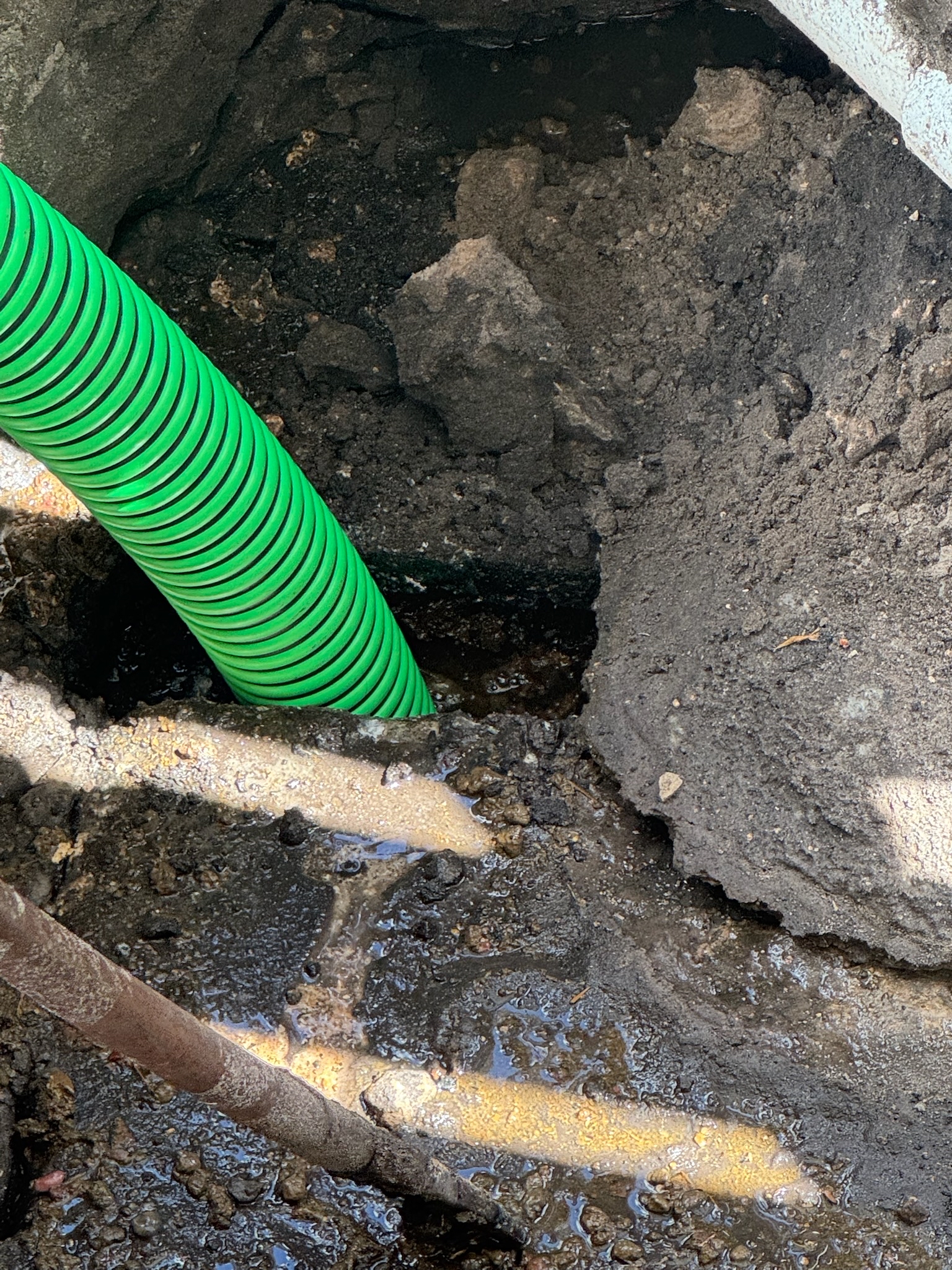 Septic technician servicing a tank with a pump truck in monroe County.