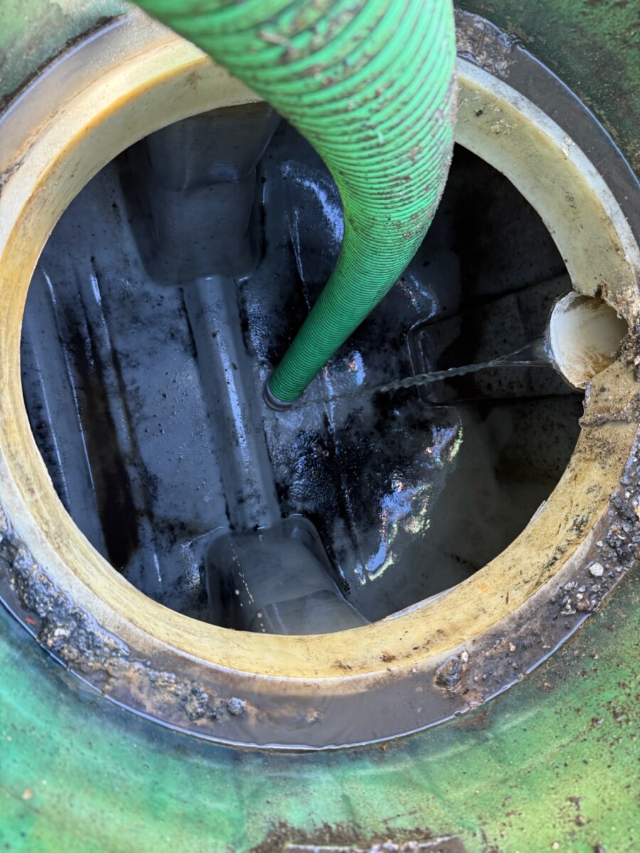 Lin’s Septic technician pumping a residential septic tank in Miami-Dade County
